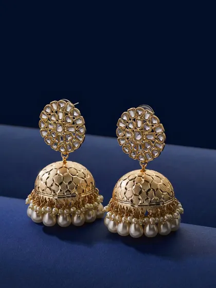 Capturing traditional Jhumkas is a challenge I wanted to get just right. For these gold and pearl earrings, I used a deep blue background to make the gold pop. The lighting is soft but precise, highlighting the intricate metalwork and the luster of the pearls.