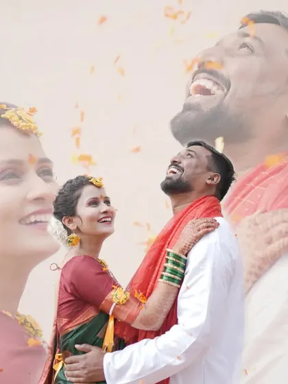 A creative double-exposure photograph blending portraits of the bride and groom with a joyful moment of them being showered with flower petals during their wedding.