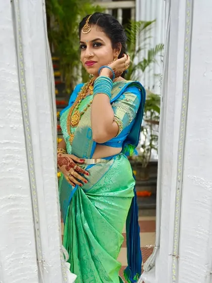 A beautiful candid-style photo of Kavya, showing the side profile and the detailed hairstyle.