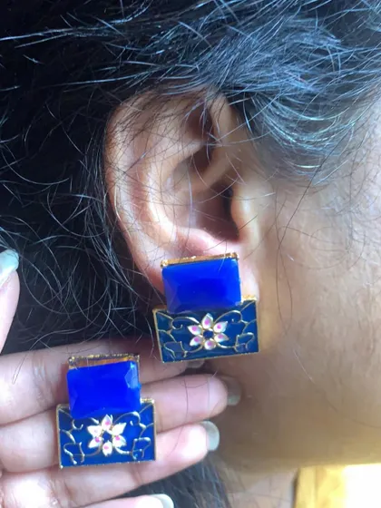 These sold-out Meenakari stud earrings feature a royal blue hand-painted base with a delicate pink flower. The two-tiered design is both modern and elegant.