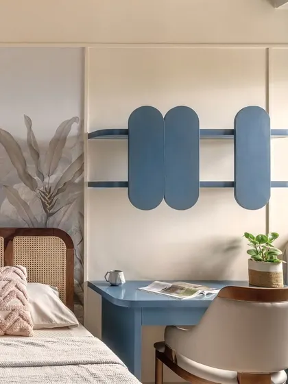 This bedroom corner features a study nook in a calm, muted blue, providing a gentle contrast to the room's warm tones. The design is a perfect blend of function and flow, ideal for focus and creative work.