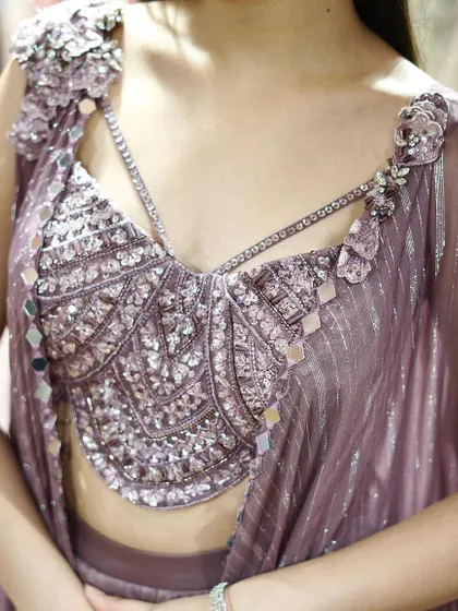 A close-up of the stunning embellished and mirror-work blouse from my mauve dhoti-cape set. It's all about the dazzling details.