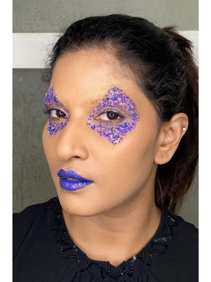 Creating sharp, geometric shapes with glitter is one of my favorite techniques for an edgy editorial concept. Here, I used purple glitter to craft a diamond shape around the eye, paired with a bold purple lip.