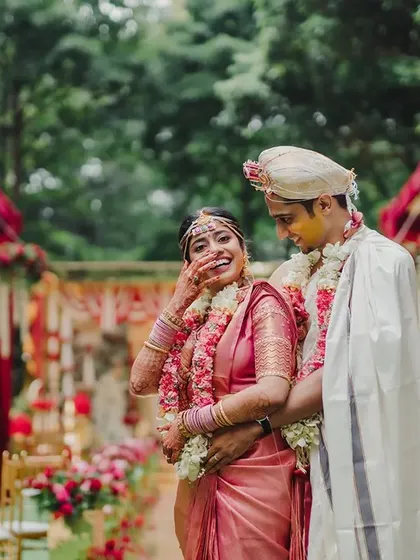 Amidst all the grandeur, it's the candid moments of laughter and love that are truly magical. Here, the couple shares a joyful moment, their happiness amplified by the beautiful floral setting we created for them.