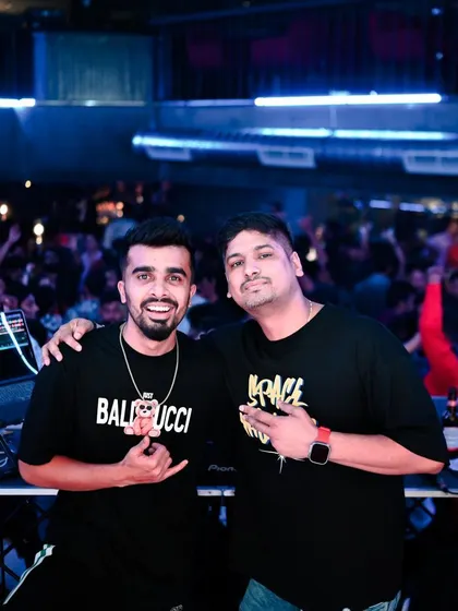Posing with a fellow DJ in front of a packed club. A picture of a successful night and a great collaboration.