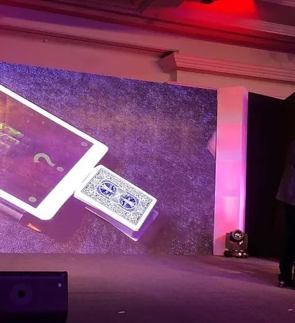 This is where technology and illusion collide on the big stage. For this corporate show, I created a custom digital illusion where a chosen card magically materializes from an iPad displayed on a massive LED screen, creating a high-impact moment for the entire audience.
