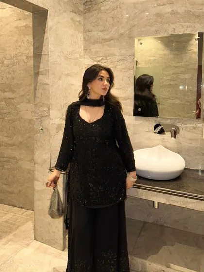 Another pose in the black suit, showing off its flattering silhouette and sparkling details.