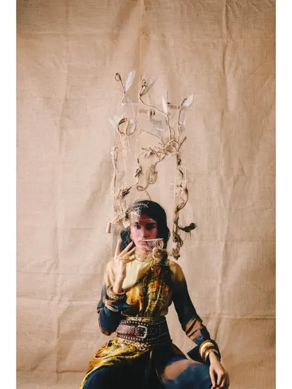 A surreal and artistic look from 'Neo-Boheme'. The styling includes a unique, branch-like headpiece, pushing the boundaries of conventional fashion.