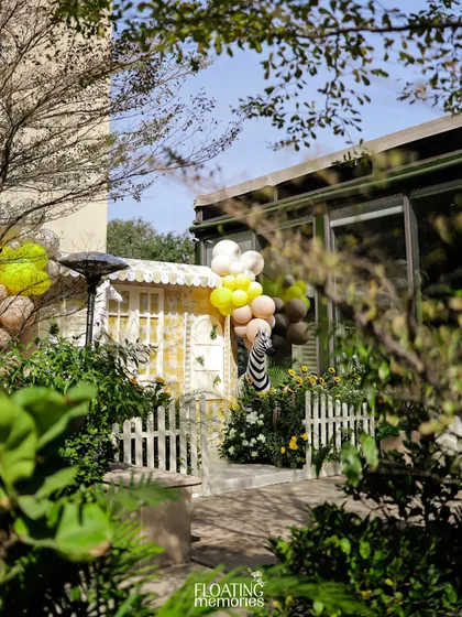 An establishing shot of the Sunlit Safari setup, nestled in a beautiful garden venue. We love transforming outdoor spaces into magical worlds.