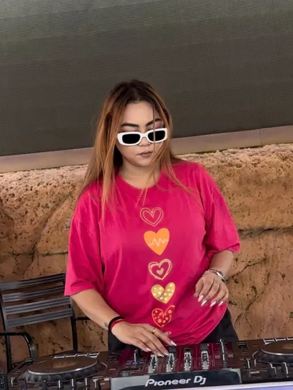A cool, casual shot of me at an outdoor daytime event, ready to spin some tracks.