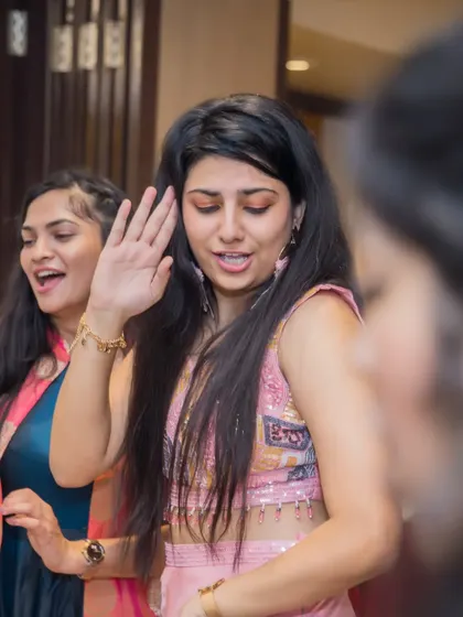 Guests dancing and singing along, creating an atmosphere of celebration and joy at the Sangeet.