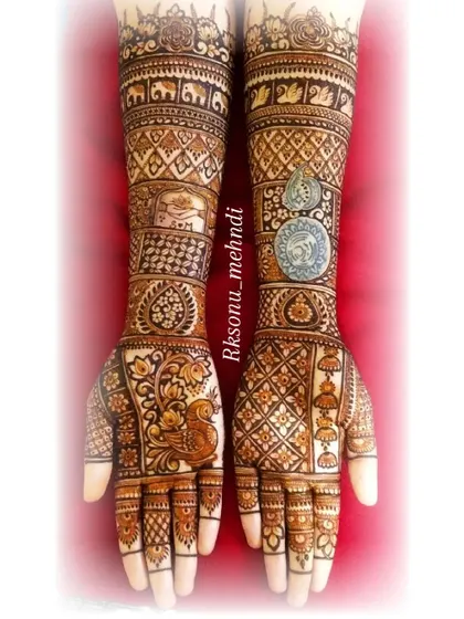 A grand bridal design inspired by the work of a fellow artist. This piece features peacocks, elephants, jhumkas, and even a coin motif, showcasing a wide range of artistic skills.