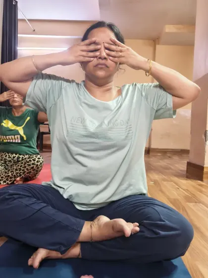 Two students practicing Bee Breath together in class. This technique is particularly beneficial for lowering blood pressure, relieving headaches, and promoting restful sleep.