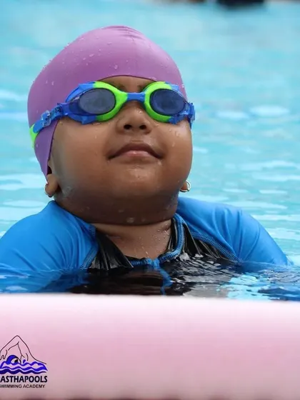 A young swimmer looks on with determination. We nurture focus and resilience, encouraging kids to embrace challenges in the pool.
