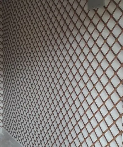 A geometric trellis pattern wallpaper in brown and white installed on a large wall.