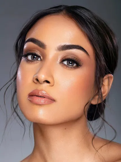 A close-up on the model's face, highlighting the flawless skin and the subtle enhancement from the lashes. The neutral makeup palette keeps the look fresh, clean, and modern.