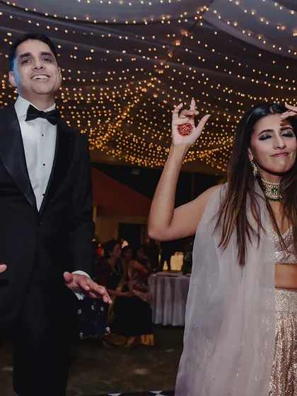 Candid moments of fun and laughter on the dance floor under a ceiling of fairy lights are what make a reception truly special.
