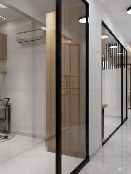 The office corridor, lined with glass partitions that allow natural light to flow through the workspace.