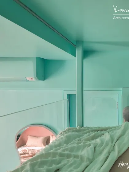 A view from the loft bed in Project 704, looking down into the cozy bed nook below. The design creates a fun, multi-level experience for kids, with separate spaces for sleeping and playing.