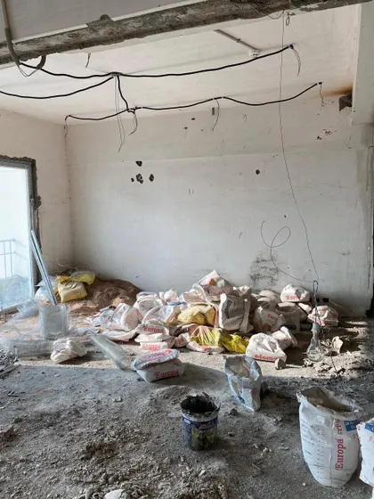 Before: The living area of our Lotus 300 project, a raw space filled with construction materials, awaiting its transformation.