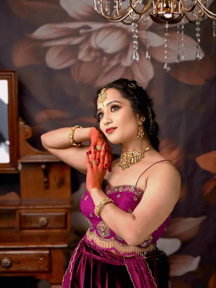 A soft, artistic pose that highlights the beautiful hairstyle and the glowing makeup.