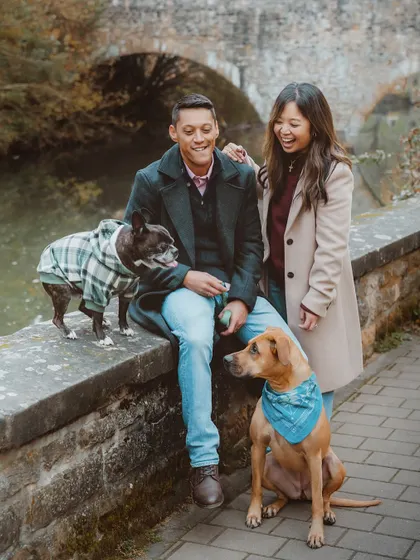 What started as a client shoot turned into a great friendship! Here's a candid moment of laughter on a rustic bridge in Luxembourg with their two adorable, stylishly dressed dogs.