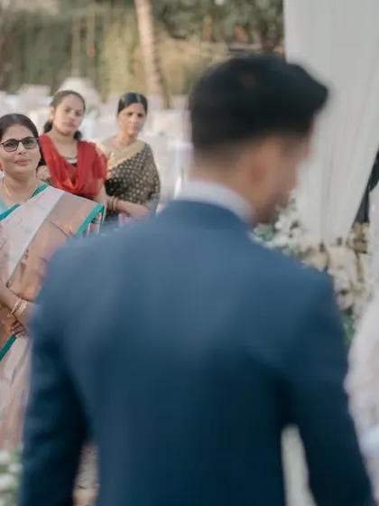 A poignant moment during the ceremony, focusing on the parents' expressions as they watch their daughter get married.