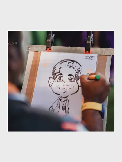 A caricature artist captures a guest's likeness, providing a unique and personal party favor for them to take home.