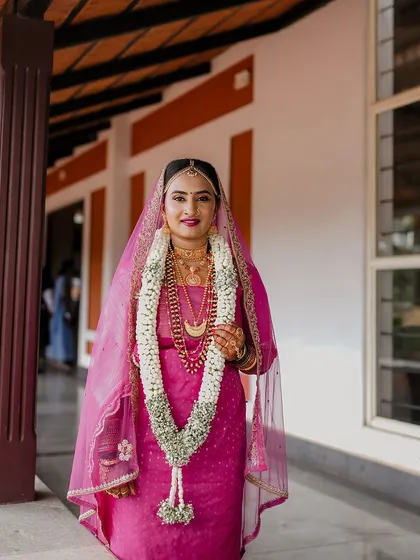 Another beautiful portrait of the bride in her pink bridal saree, showing the complete look from head to toe.