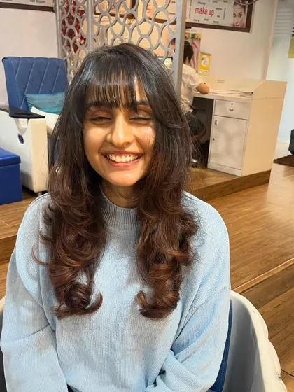 A happy client with her new, easy-to-style haircut.