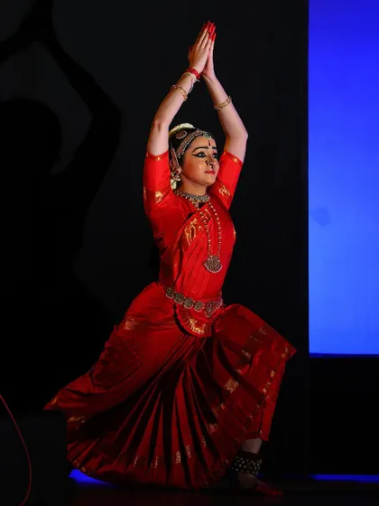 A pose of salutation, with hands joined in an anjali mudra. This is a recurring gesture of respect that marks the beginning and end of many pieces.