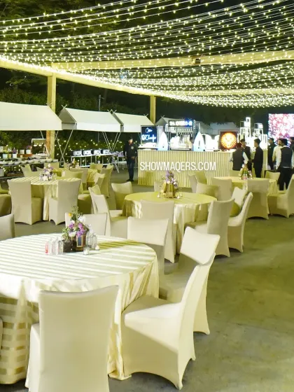 The outdoor seating and catering setup for the reception, illuminated by thousands of warm fairy lights.