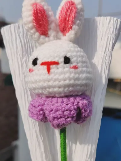 A close-up of the bunny head on the flower stem.