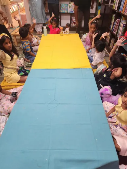 Little hands shoot up, full of excitement and ready to participate. This photo captures the interactive nature of our parties, where every child is encouraged to join in the fun.
