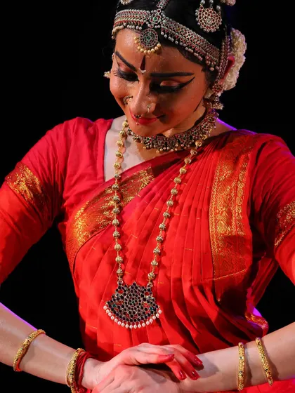 A close up showing a moment of quiet reflection and inner joy. The dance is not just about movement, but also about the internal emotional journey.
