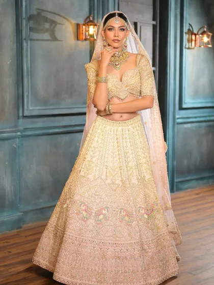 The bride seated, her lehenga spread around her. The look is regal and sophisticated, with makeup that is both timeless and modern.