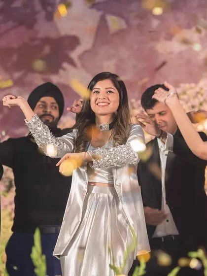 The whole family comes together for a finale, showering the stage with confetti. We help create a memorable end to the sangeet.