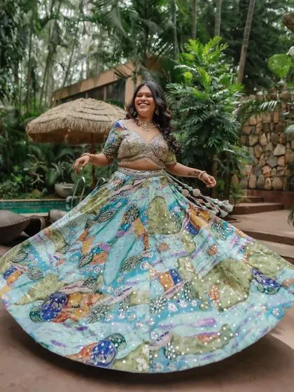A joyful twirl! The makeup and hair are set to last through all the fun and dancing of a Mehendi or Haldi event.