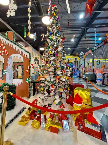 'Tis the season for parties! Our space decorated for a Christmas-themed celebration, featuring a beautiful tree and gingerbread house.