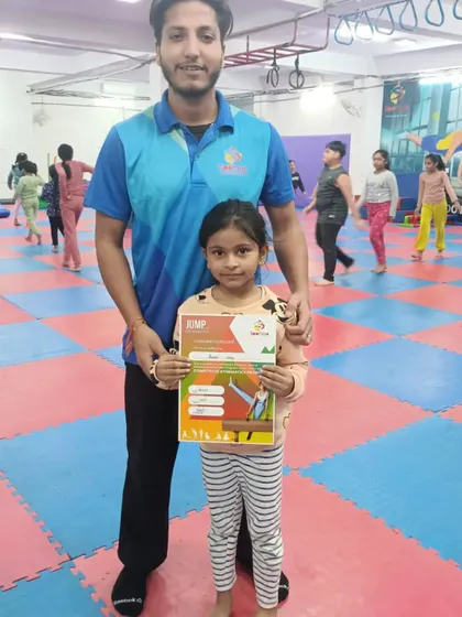 Another happy student is recognized for her progress with a certificate.