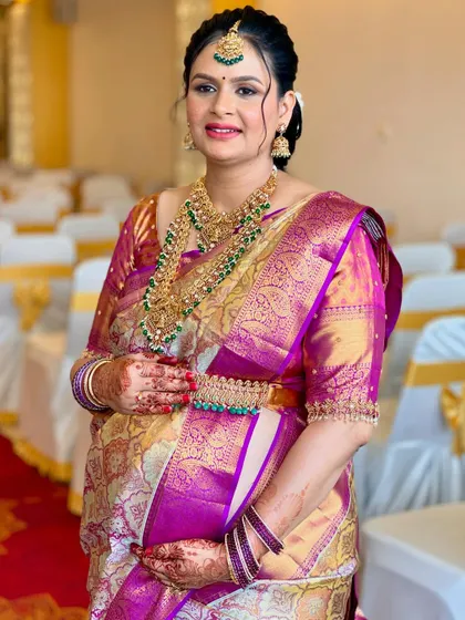 A closer look at the flawless HD makeup for Usha's baby shower. The focus is on luminous skin, defined eyes, and a lip color that complements her entire ensemble.