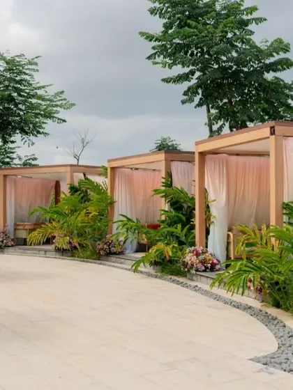 A row of pastel-draped cabanas lines the poolside.