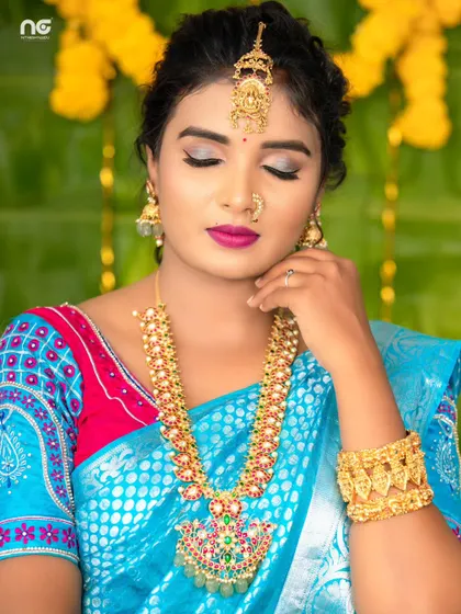 A close-up of the model, her eyes closed, highlighting the makeup and the beautiful details of the necklace and maang tikka.