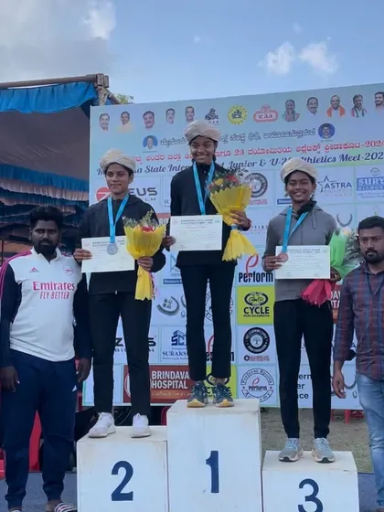 On the podium for the 80m hurdles. Our athlete stands at the number one spot after her record-breaking performance.