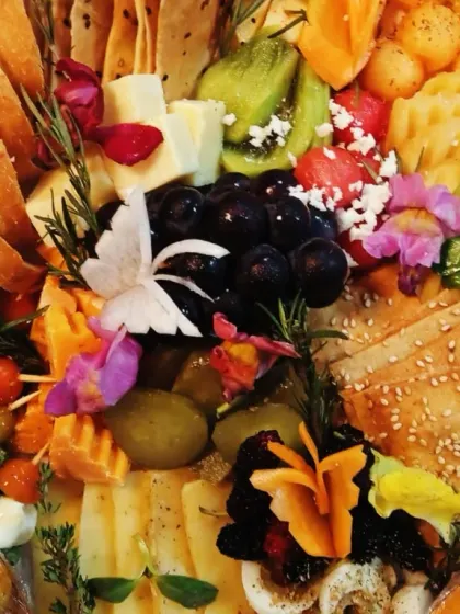 Tiny butterfly shapes sit among fruit, crackers and little bites, bringing a playful detail to our charcuterie garden.