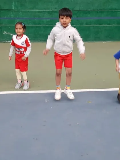 Jump for joy! A warm-up exercise gets the kids energized and ready for their football class. We incorporate fun fitness drills to improve their agility and coordination.