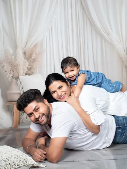 A happy family portrait with their baby girl, capturing a moment of pure joy and connection.