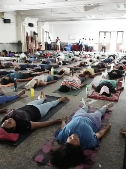The hall filled with practitioners resting in Savasana. It's a powerful sight to see so many people finding stillness together.