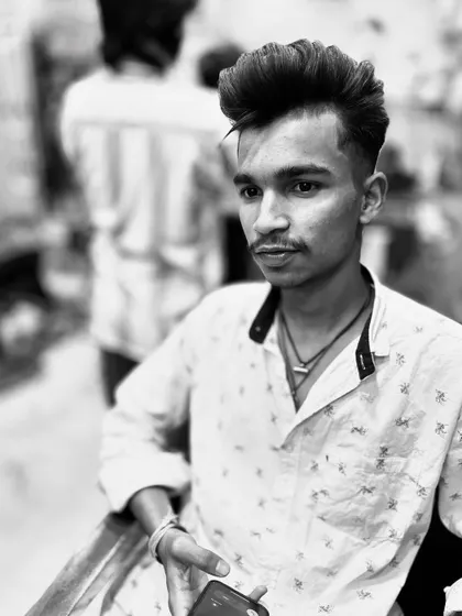 A front-on view of a styled pompadour with faded sides. Even in black and white, the texture and volume I create on top are clearly visible.