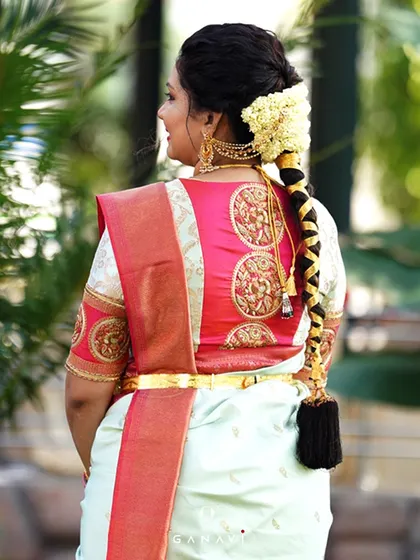 A view of the back of Sanjana's blouse, featuring intricate circular motifs embroidered in gold. This design adds a beautiful and traditional touch to her unique ensemble.